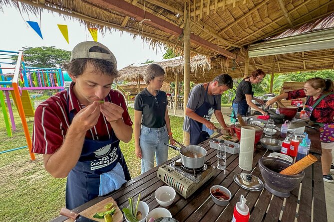 Aroidee’s Farm-Fresh Thai Cooking Experience - Picking herbs and vegetables in the organic garden